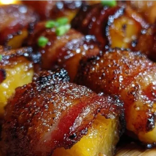 Delicious homemade bacon-wrapped pineapple bites on a serving platter