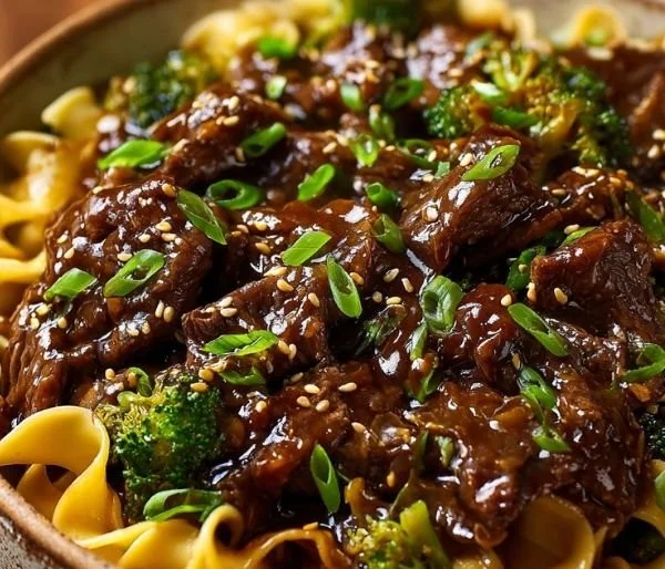 Delicious beef and noodles served on a plate with fresh herbs
