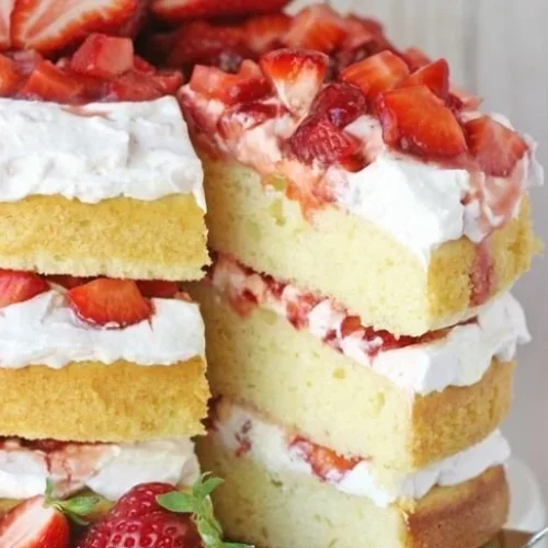 Delicious strawberry shortcake cake with fresh strawberries and whipped cream