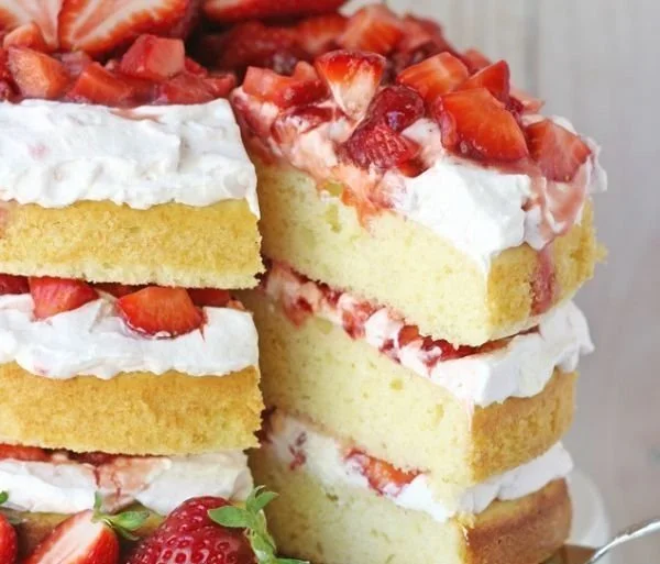 Delicious strawberry shortcake cake with fresh strawberries and whipped cream