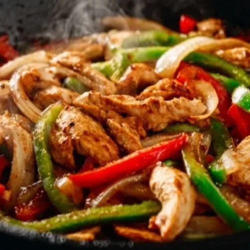 Plate of mouth-watering Black Pepper Chicken garnished with colorful vegetables