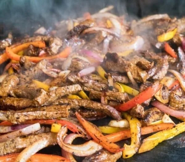 Delicious Blackstone steak fajitas served on a sizzling platter