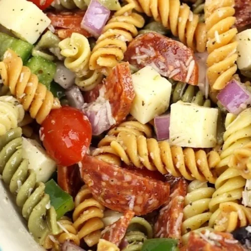 Easy classic pasta salad with fresh vegetables in a bowl.