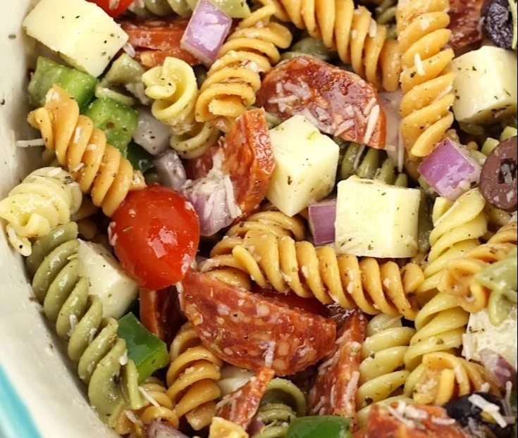 Easy classic pasta salad with fresh vegetables in a bowl.