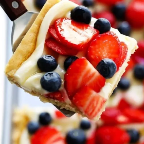 Delicious easy fruit pizza topped with colorful fresh fruits and cream cheese frosting