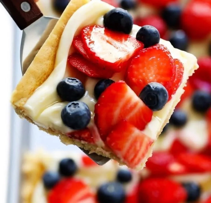 Delicious easy fruit pizza topped with colorful fresh fruits and cream cheese frosting