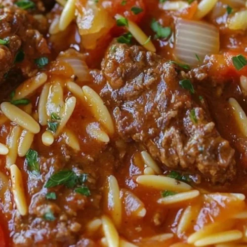 Bowl of Greek Barley Soup garnished with fresh herbs and vegetables