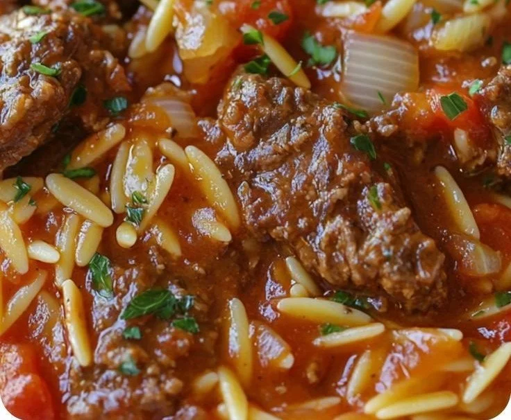 Bowl of Greek Barley Soup garnished with fresh herbs and vegetables