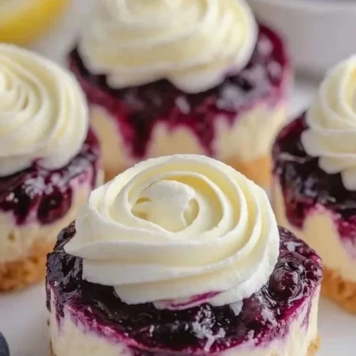 Healthy mini lemon blueberry cheesecakes with vibrant blueberries and lemon zest