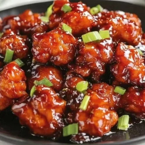 Delicious homemade Mongolian Chicken served with vegetables and rice.