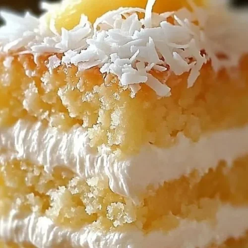 Sliced Pineapple Coconut Dream Cake on a plate with tropical decorations