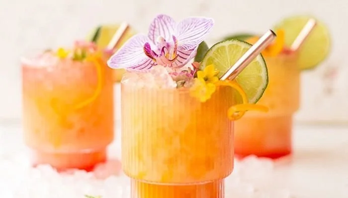 Tropical Pineapple Mango Rum Punch in a vibrant glass garnished with fruit.