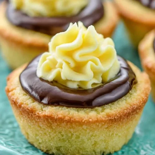 Boston Cream Pie Cookie Cups topped with chocolate and creamy filling
