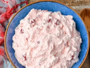 Delicious and light Cherry Fluff dessert served in a bowl with cherry toppings.