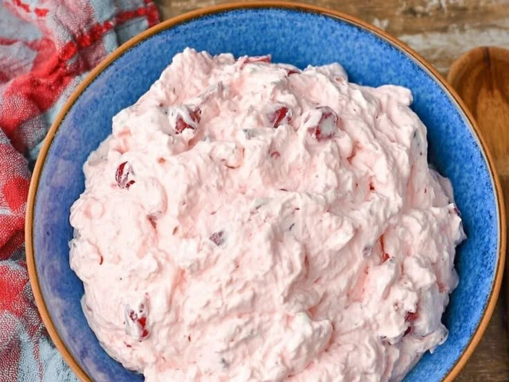 Delicious and light Cherry Fluff dessert served in a bowl with cherry toppings.