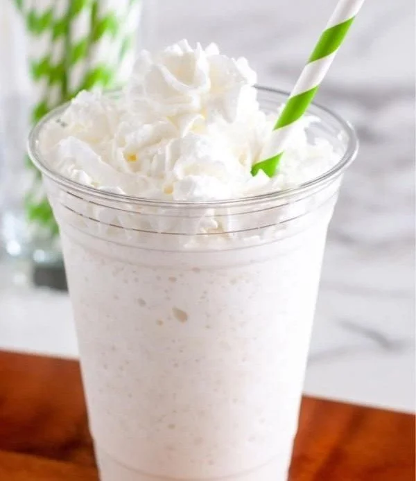 Homemade Vanilla Bean Frappuccino topped with whipped cream and vanilla beans.