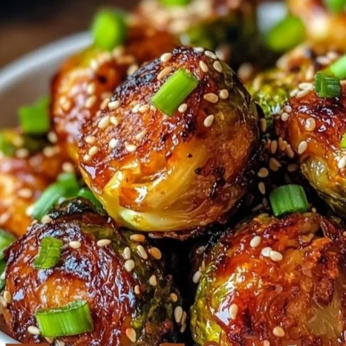 Delicious Honey Sriracha Brussels Sprouts garnished with sesame seeds