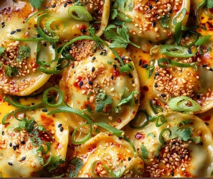 Oven-baked dumplings in coconut curry sauce served in a bowl.