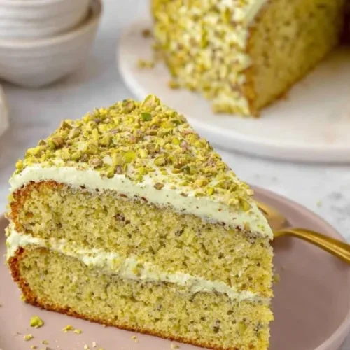 Delicious homemade pistachio cake with frosting and pistachio nuts on top