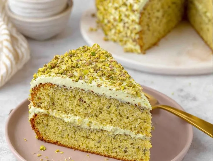 Delicious homemade pistachio cake with frosting and pistachio nuts on top