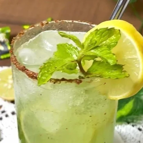 Delicious Raw Mango Mocktail garnished with fresh mint and sliced mango.