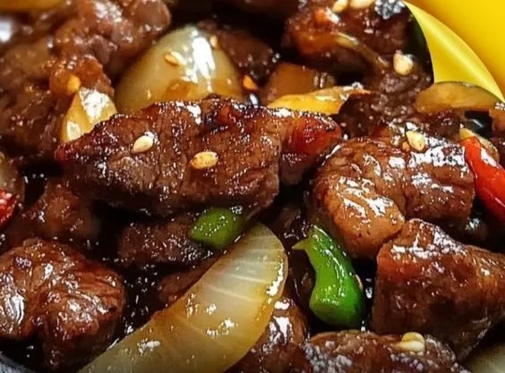 Sizzling Chinese Pepper Steak with Onions served in a bowl