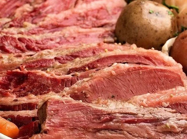 Slow Cooker Corned Beef and Cabbage dish with vegetables in a bowl.