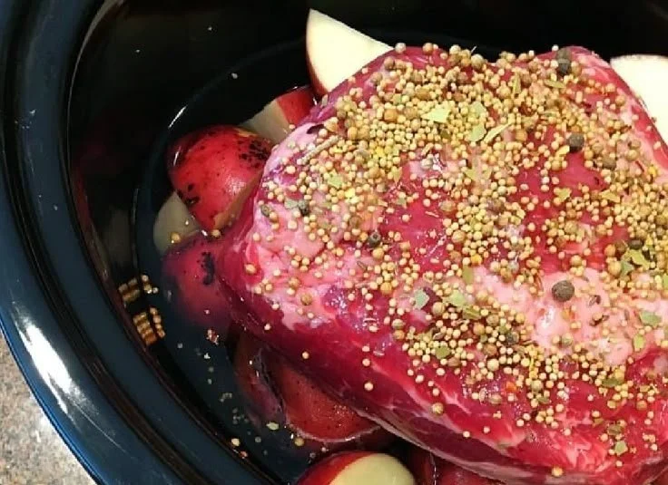 Slow-cooker corned beef brisket in a serving dish with vegetables