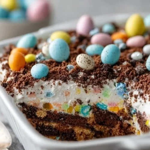 Ten minute Easter Dirt Cake topped with colorful candy and chocolate soil.