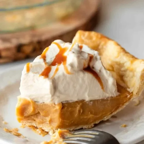 Delicious homemade butterscotch pie topped with whipped cream