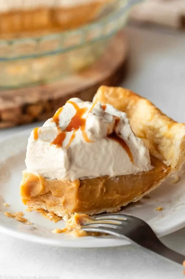 Delicious homemade butterscotch pie topped with whipped cream