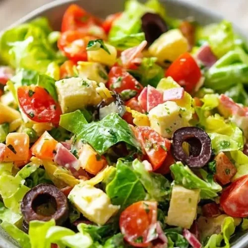 Bowl of Easy Italian Chopped Salad with fresh vegetables and dressing