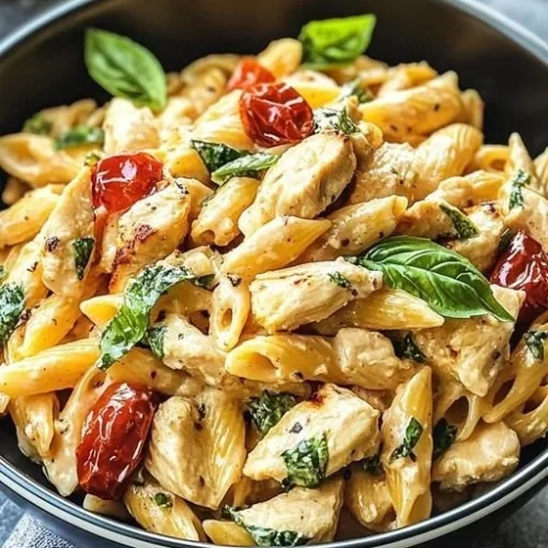 Plate of Marry Me Chicken Pasta garnished with fresh basil