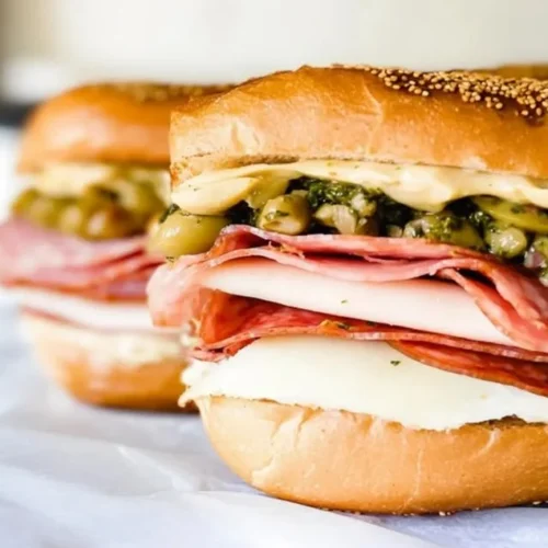 Delicious Muffuletta Sandwich with layers of meats, cheese, and olive salad