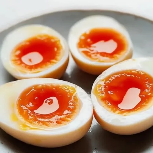 Delicious ramen egg served on top of a bowl of broth and noodles