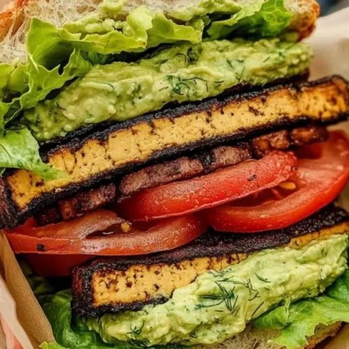 Delicious Summer Smoky Tofu Lettuce Tomato sandwich on a plate.
