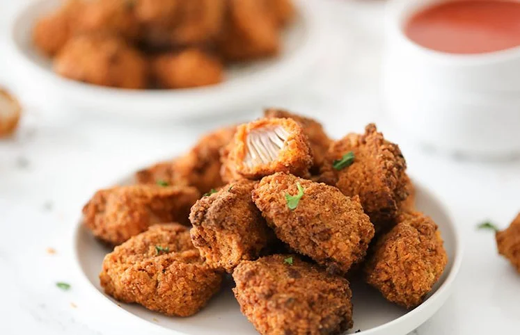 Vegan spicy chicken fried jackfruit served with fresh herbs and spices