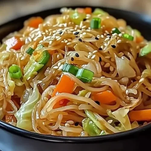 Vegetarian cabbage noodle stir-fry garnished with colorful vegetables