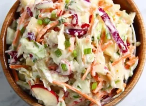 Freshly made Apple Coleslaw with apples, cabbage, and dressing.