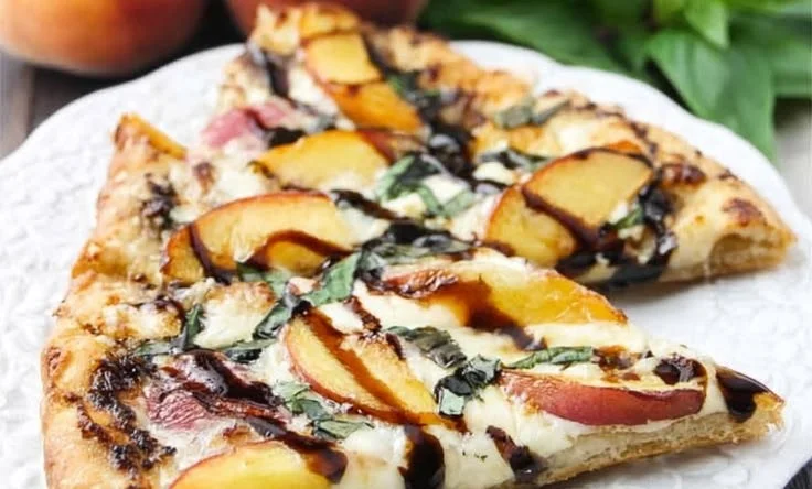 Peach and basil naan bread pizza topped with fresh ingredients.
