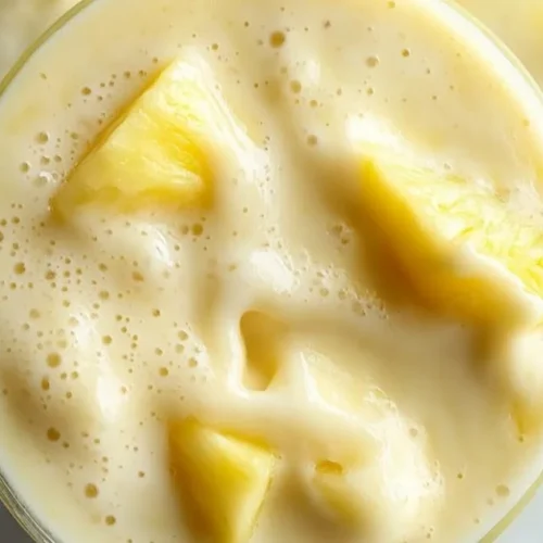Refreshing pineapple smoothie in a glass with tropical garnish