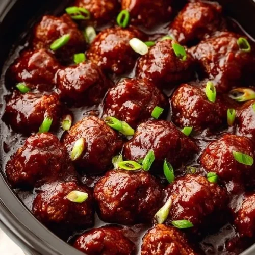 Delicious Crockpot BBQ meatballs served in a tangy sauce