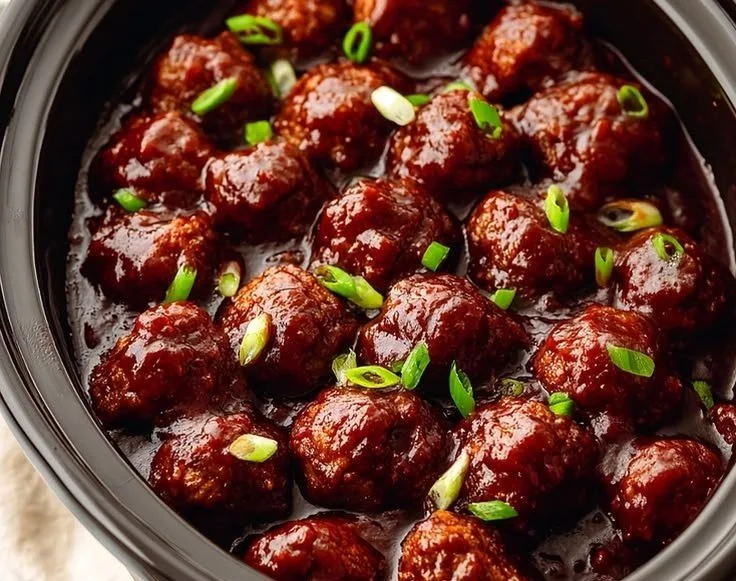 Delicious Crockpot BBQ meatballs served in a tangy sauce