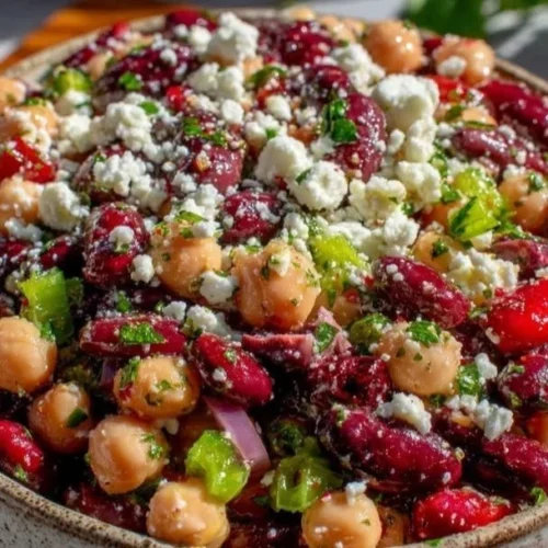 Easy dense bean salad with feta and herb vinaigrette served in a bowl.