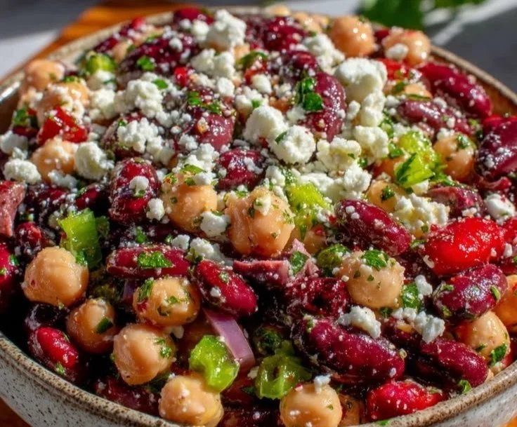 Easy dense bean salad with feta and herb vinaigrette served in a bowl.