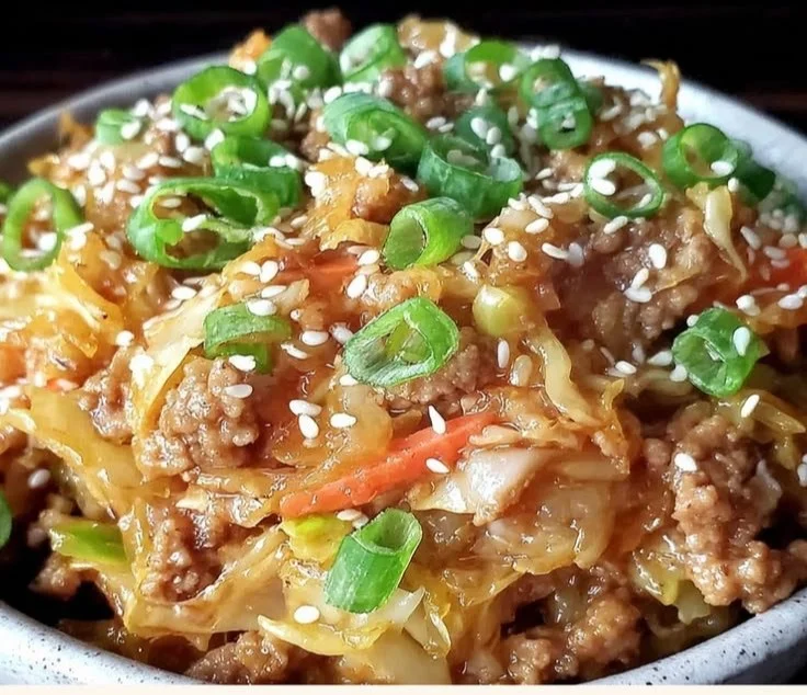 Delicious low-carb egg roll bowl topped with ginger sesame sauce