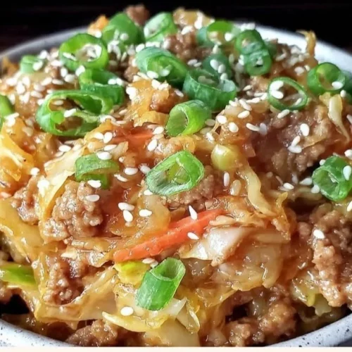 Delicious low-carb egg roll bowl topped with ginger sesame sauce for quick dinners.