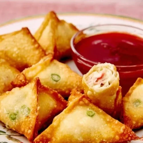 Plate of homemade Crab Rangoon served with dipping sauce