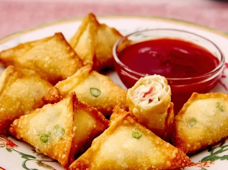 Plate of homemade Crab Rangoon served with dipping sauce