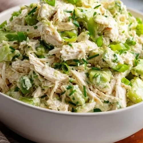 Avocado lime chicken salad bowl with fresh ingredients and vibrant colors.